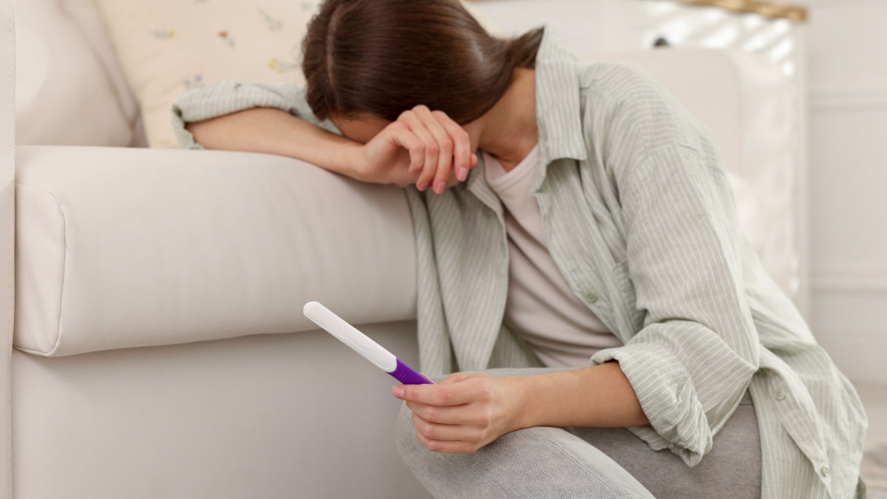 Graphic of a woman in her 30s looking thoughtful with a fertility chart