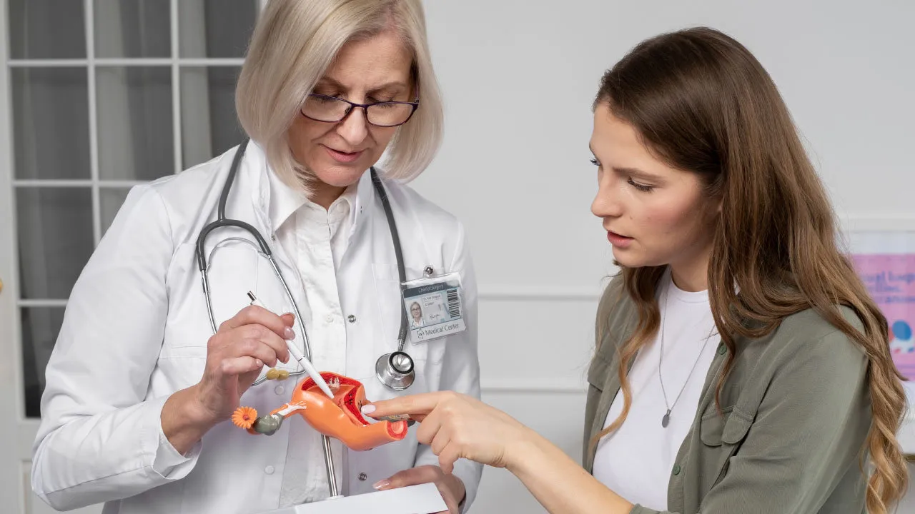 Dr discussing endometrial cancer risk factors and early detection with a patient during a gynecologic oncology consultation.