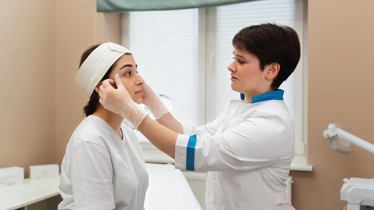 Oculoplastic surgeon examining a patient with an eyelid coloboma during an eye evaluation
