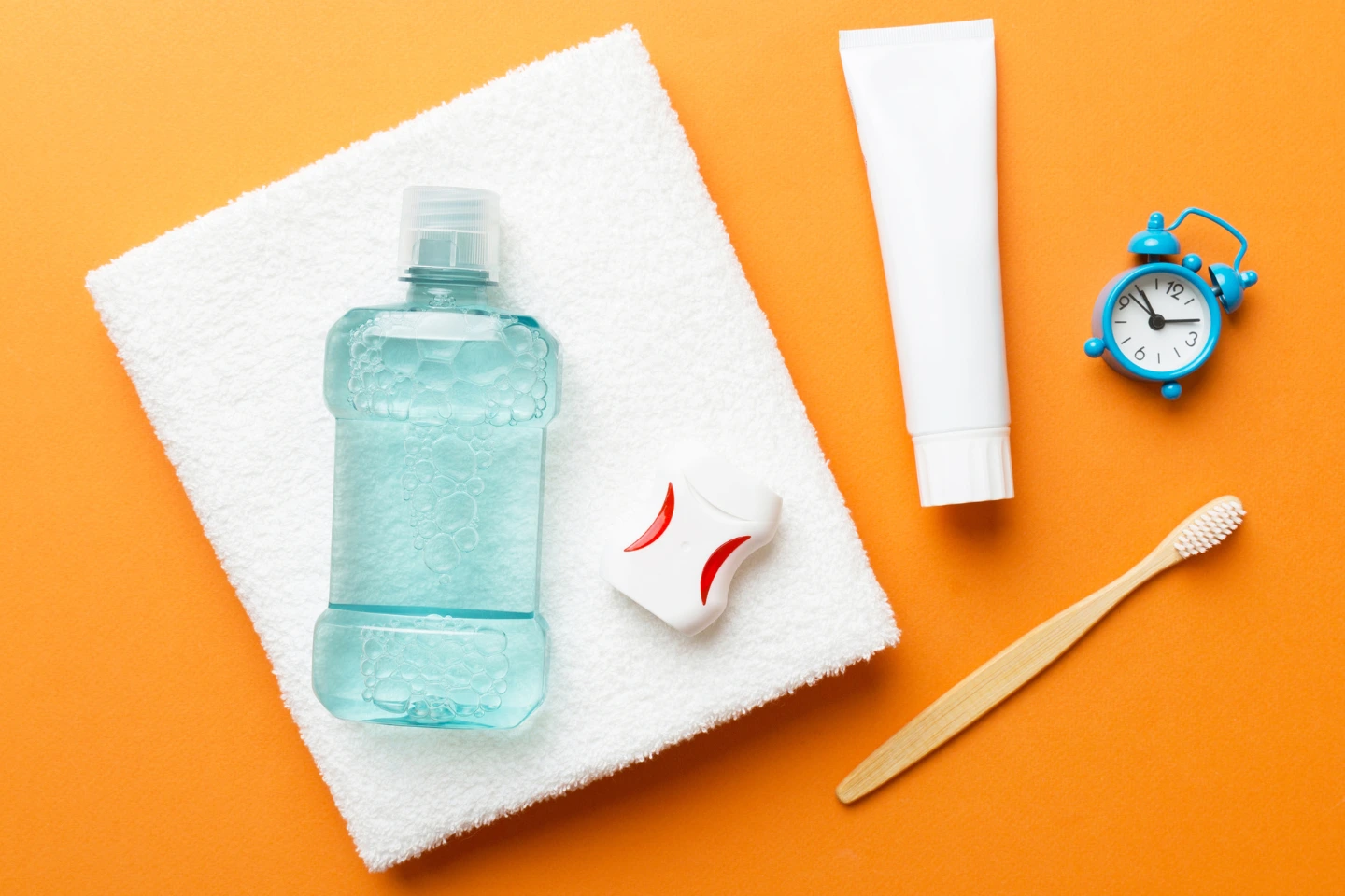 Essential oral hygiene products including toothbrush, toothpaste, floss, and mouthwash for daily dental care