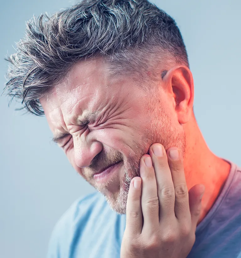 male patient in dental chair with emergency tooth ache problem