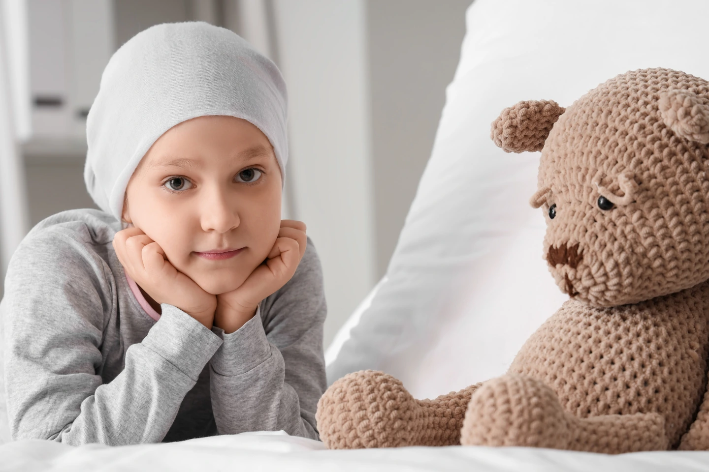 Child resting with soft toy, evoking early childhood caries awareness and pediatric dental care.