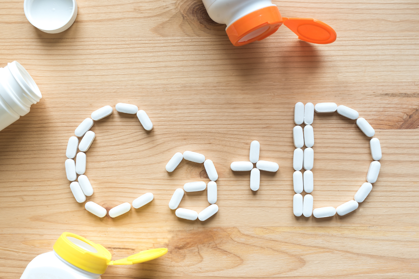 Smiling person holding a glass of milk and standing in sunlight, symbolizing Vitamin D and Calcium benefits for teeth.