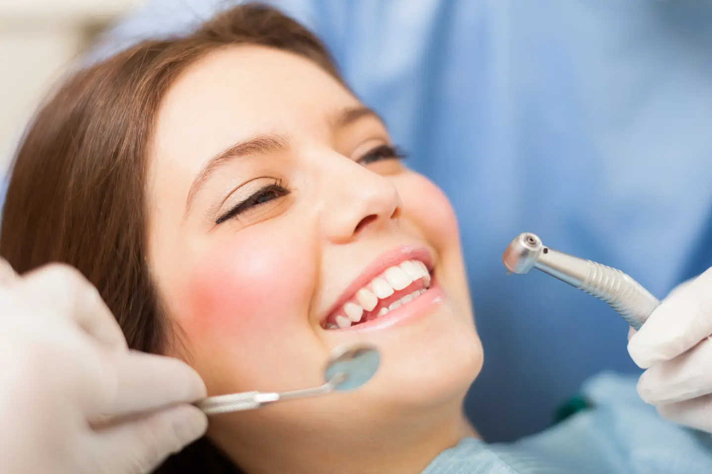 A patient at Delight Dental Studio receiving a cosmetic dental bonding consultation to close gaps between teeth and improve smile balance.