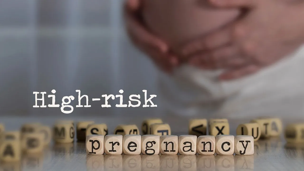 Pregnant woman consulting a gynecologist during a high-risk pregnancy checkup