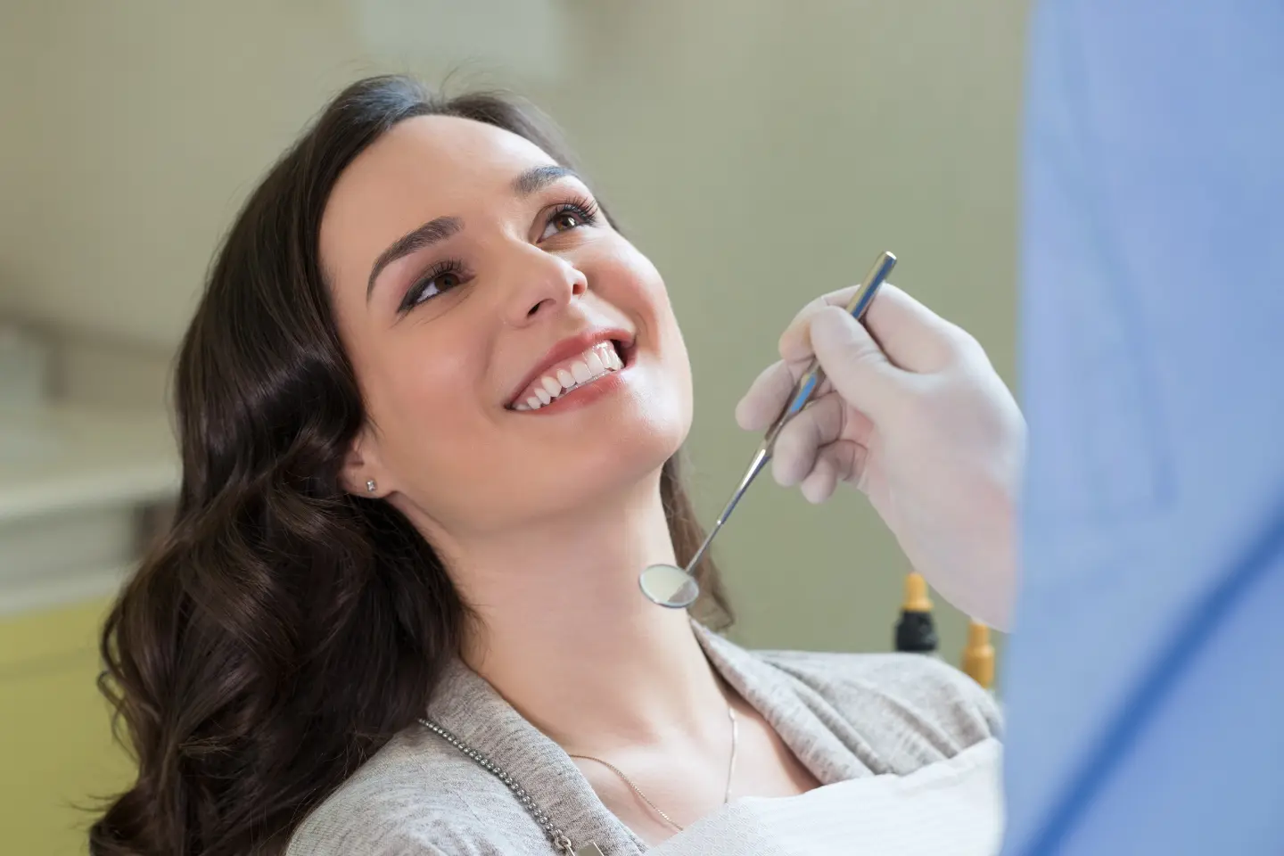 Dentist showing dental implant model to patient at Star Dental Clinic