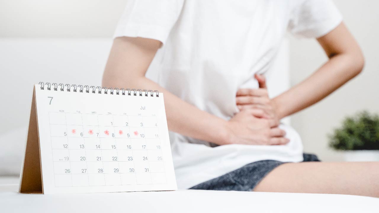 Woman Discussing Irregular Menstrual Cycle With Doctor