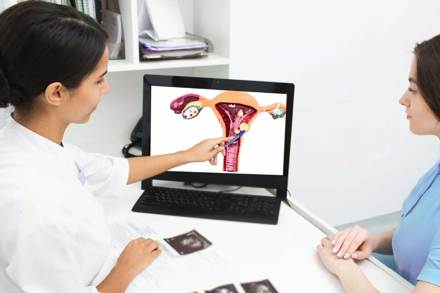 Gynecologist explaining ovarian cyst complications and warning symptoms to a patient