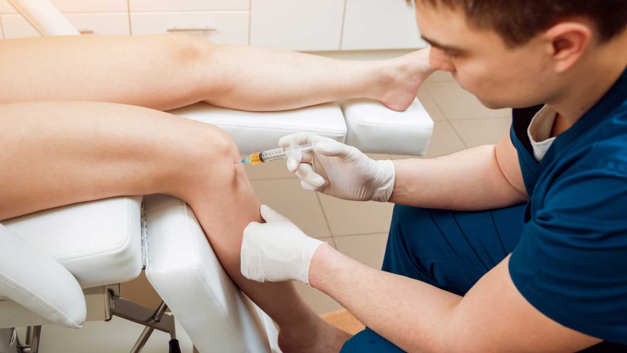 Doctor performing PRP injection for knee joint pain