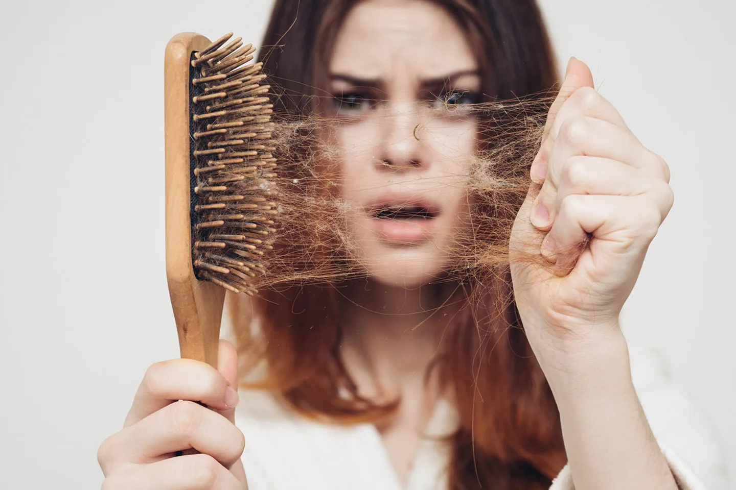 Woman with thinning hair showing hair loss concerns treated by dermatologist in Beachwood, OH