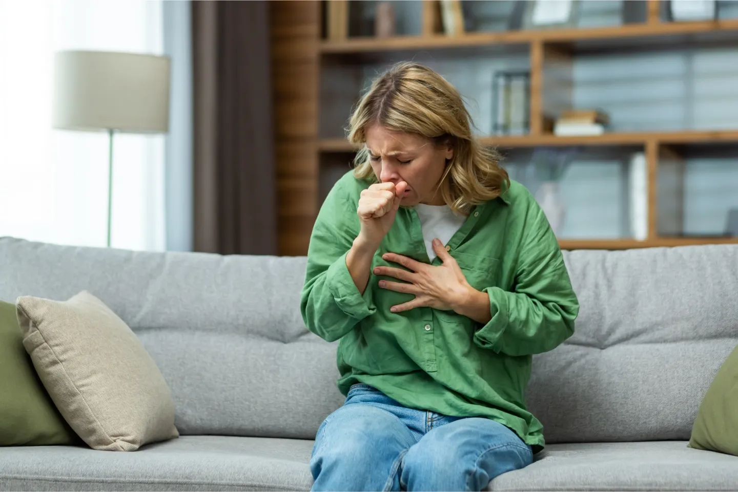 Person experiencing seasonal allergy symptoms and breathing difficulties during pollen season