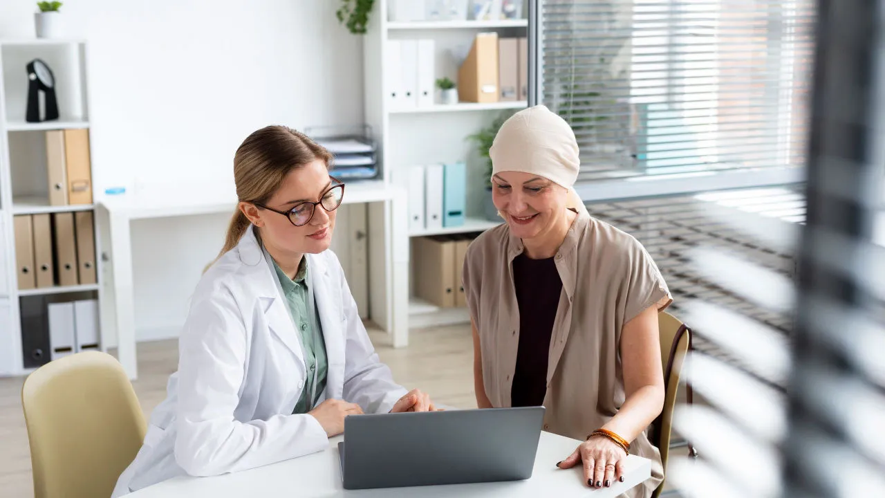 Doctor discussing personalized cancer treatment options with a patient during an oncology consultation.