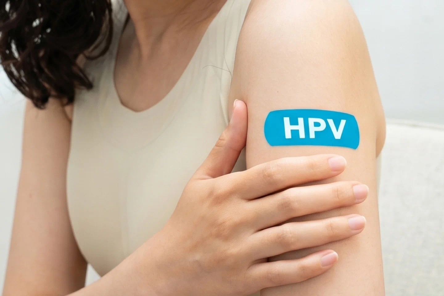 Doctor counseling a young adult about the HPV vaccine during a preventive healthcare visit
