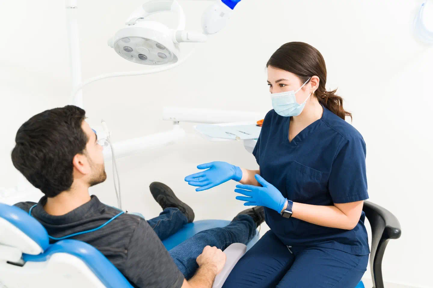 Dentist consulting with a patient in a modern dental treatment room