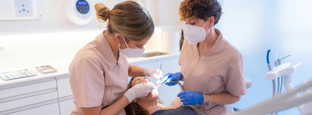 Dentists providing professional dental treatment to a patient in a modern dental clinic