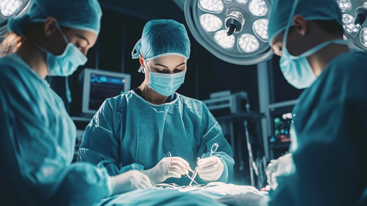 Gynecologist performing laparoscopic recanalization procedure on fallopian tube.