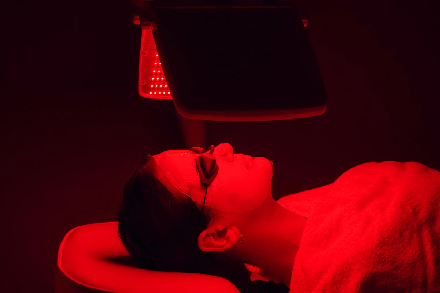 Patient receiving LED red light therapy for hair thinning at Western Reserve Dermatology, Inc. as part of non-invasive hair loss treatment options.